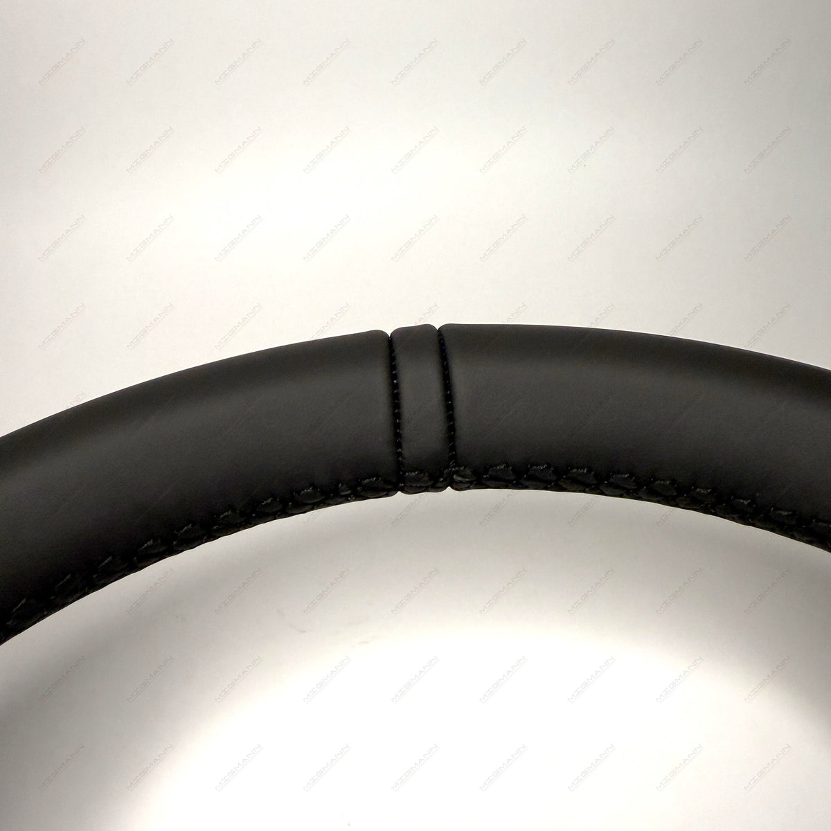 Close-up of leather top marker on Porsche 911 steering wheel
