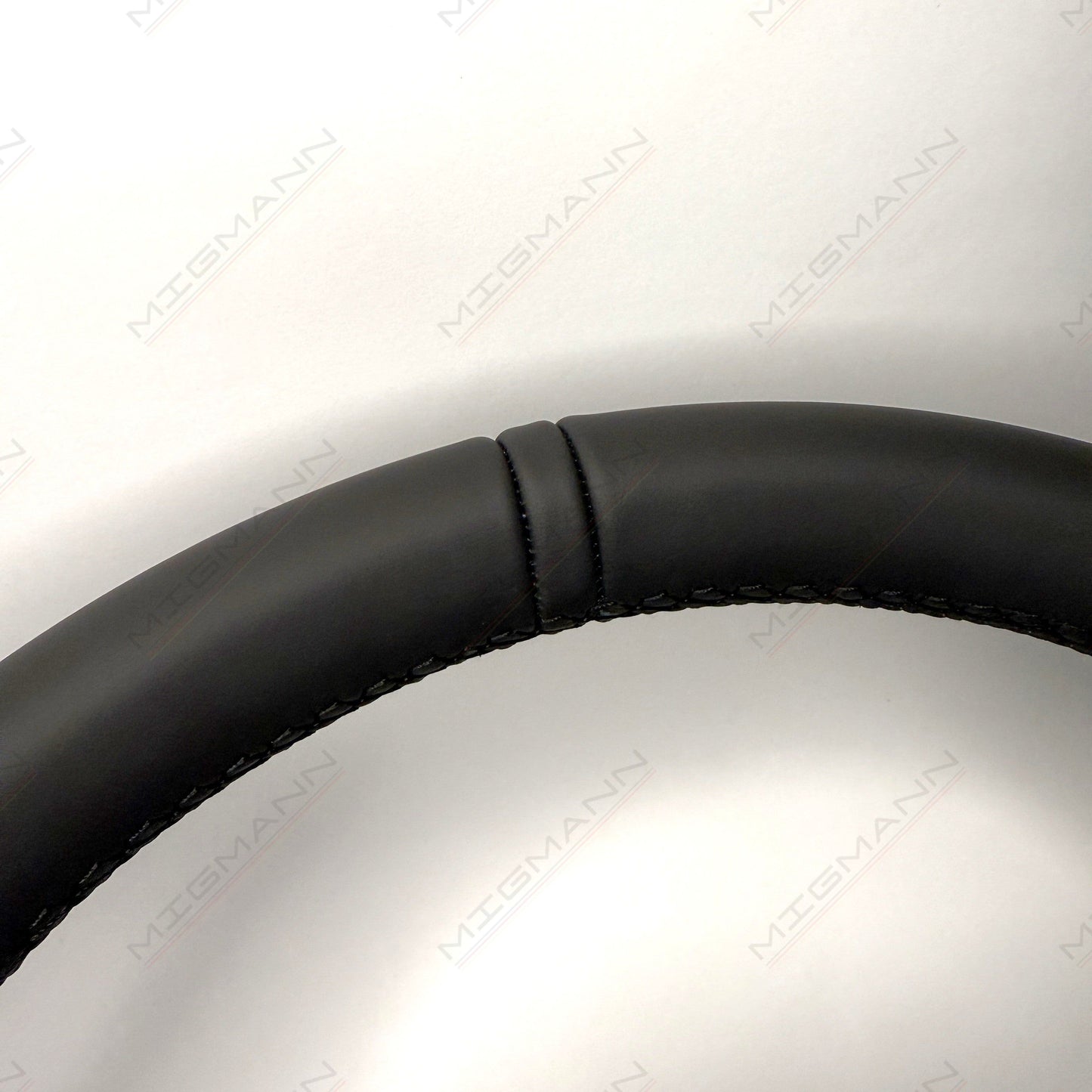 Close-up of Porsche 911 steering wheel leather top marker in black leather