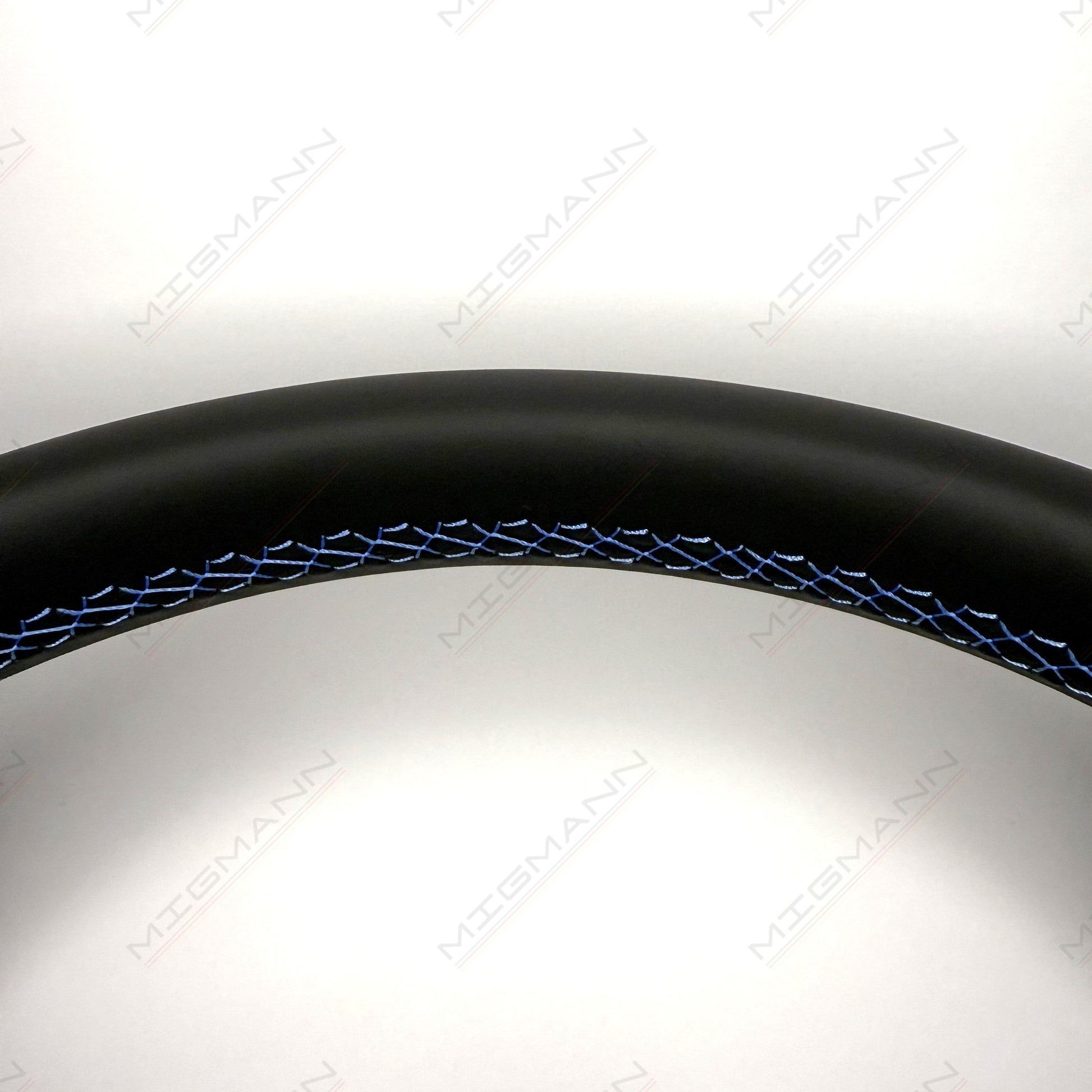 Close-up of blue GTE stitching on OEM Volkswagen steering wheel black leather