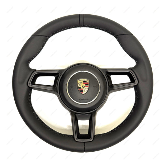Porsche 911 black leather steering wheel with black trim and airbag
