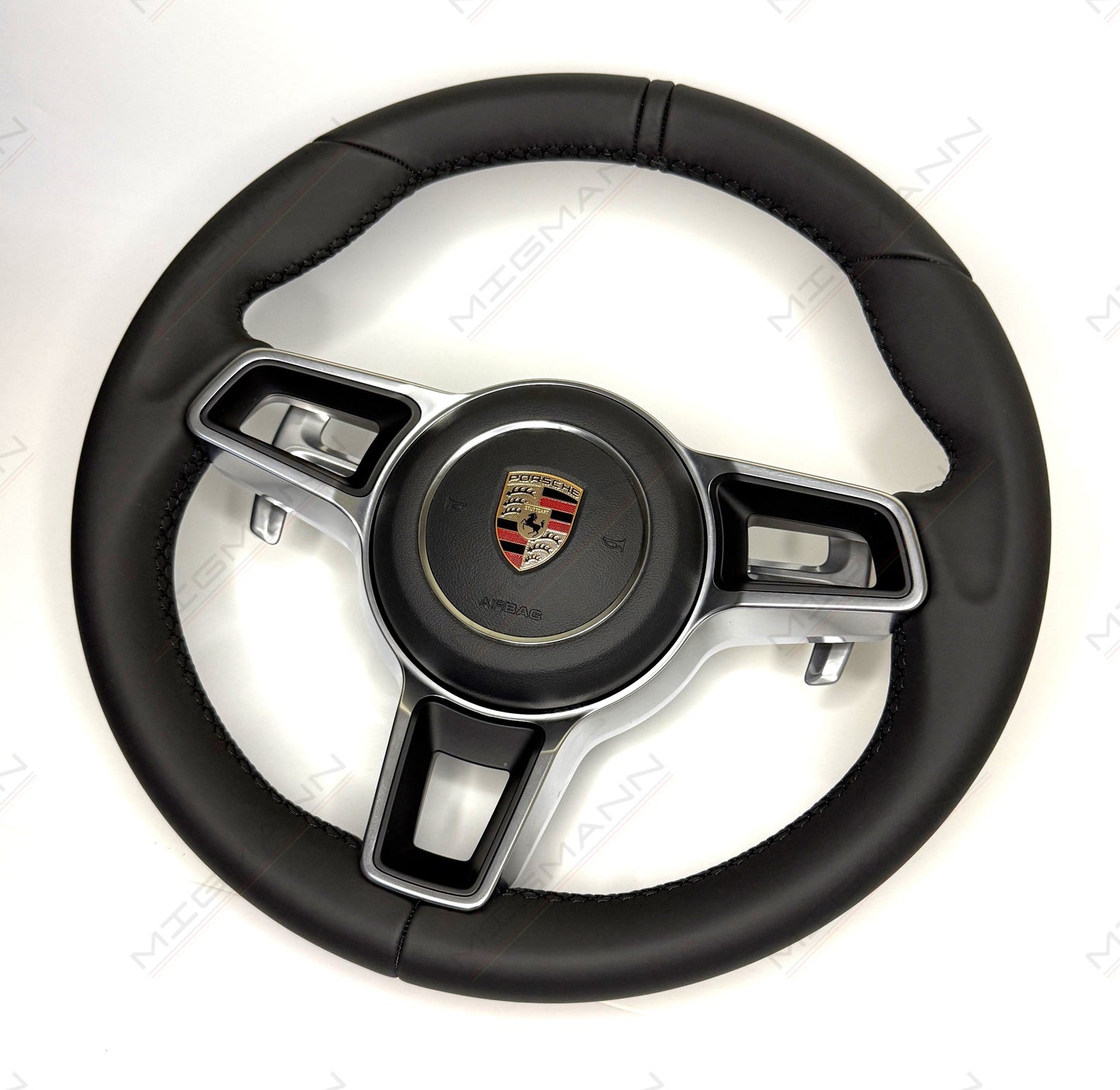 Porsche 911 PDK black leather steering wheel with paddle shifters and airbag angled view